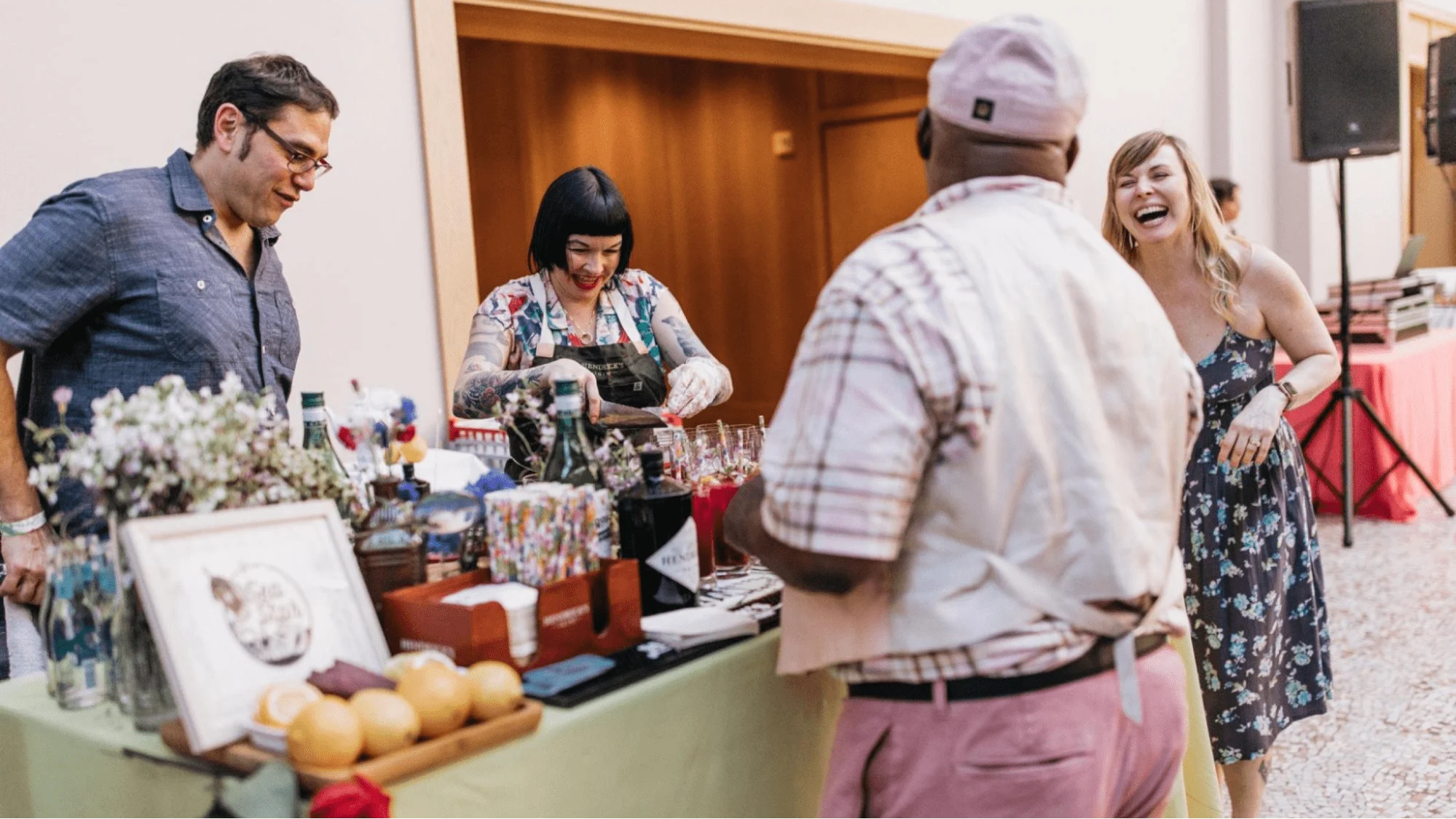 Bartender serving cocktails to guests at a private event bar