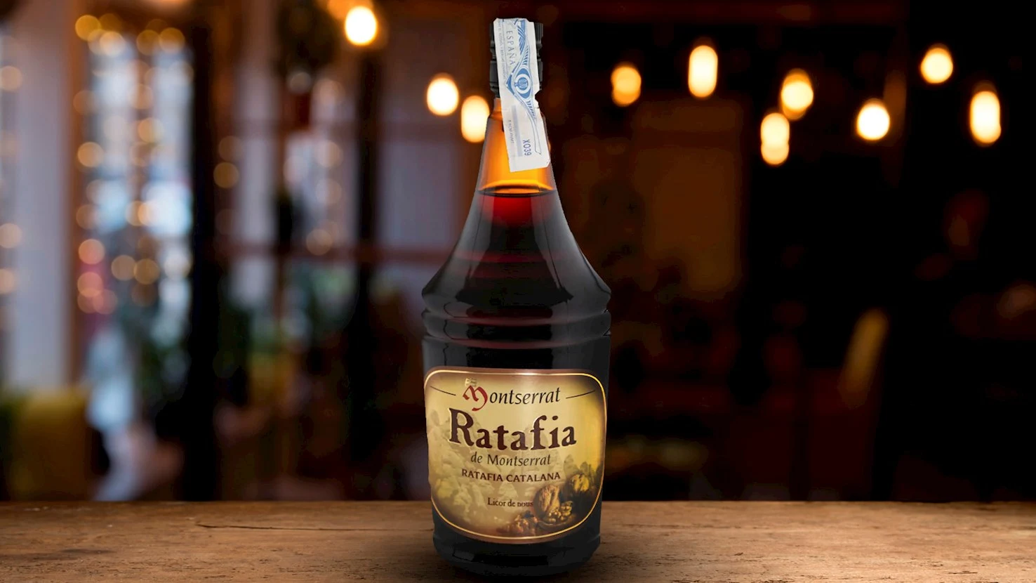 Bottle of Montserrat Ratafia liqueur on a wooden bar.