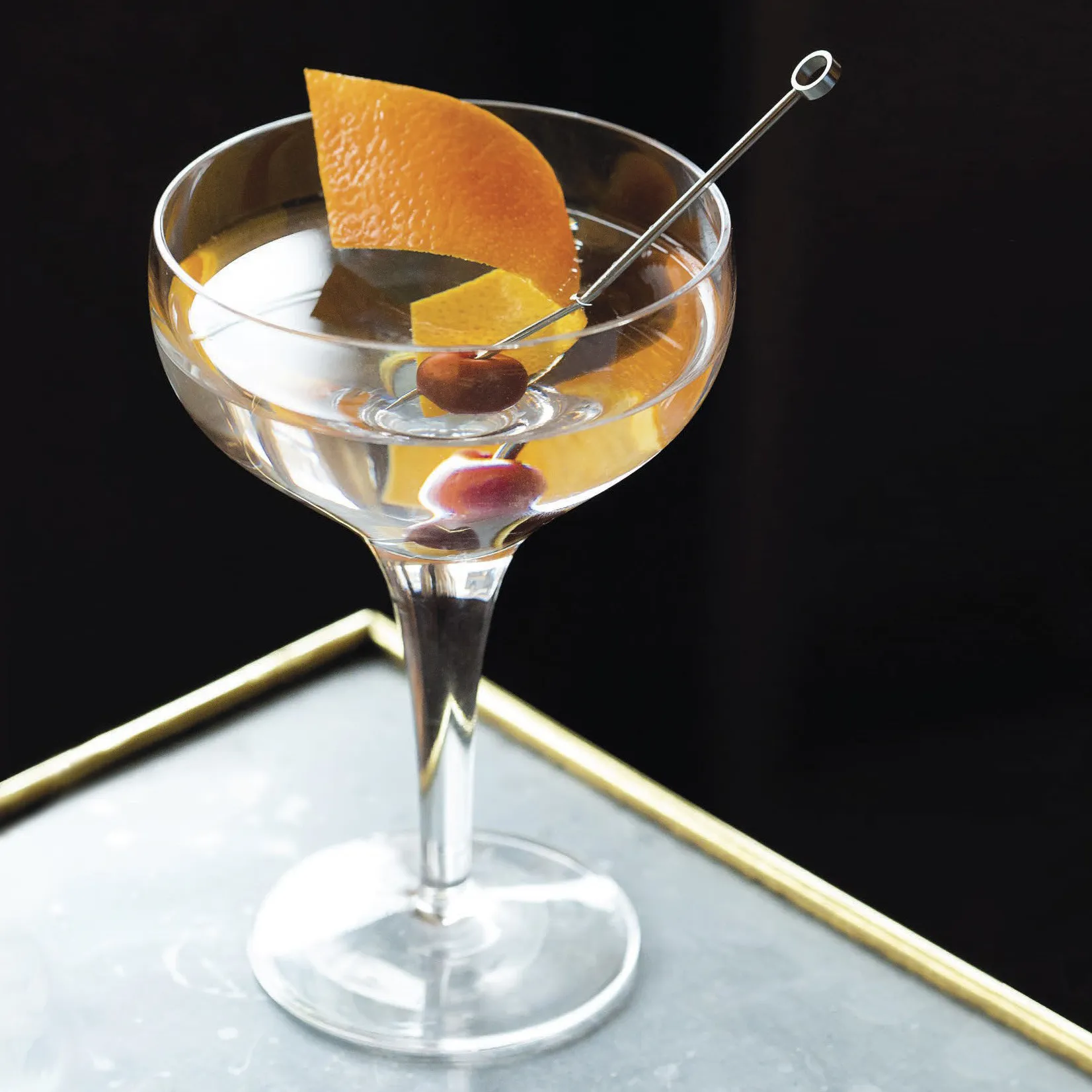 Classic Tuxedo cocktail with orange garnish in a coupe glass.