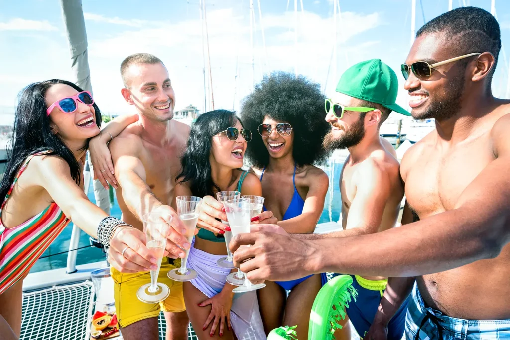 Friends enjoying drinks together on a yacht in Ibiza.