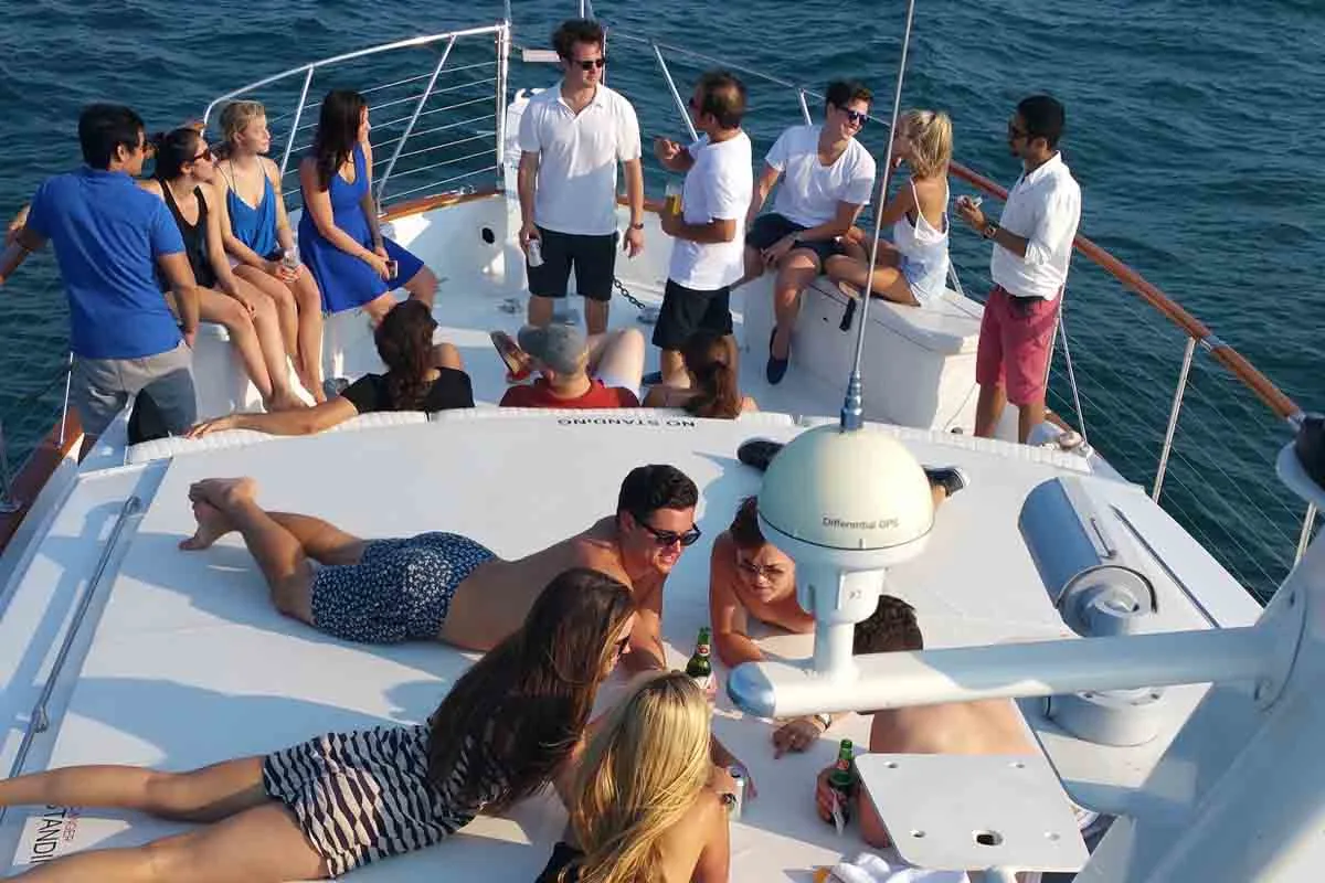 Private yacht party with guests relaxing at sea in Ibiza