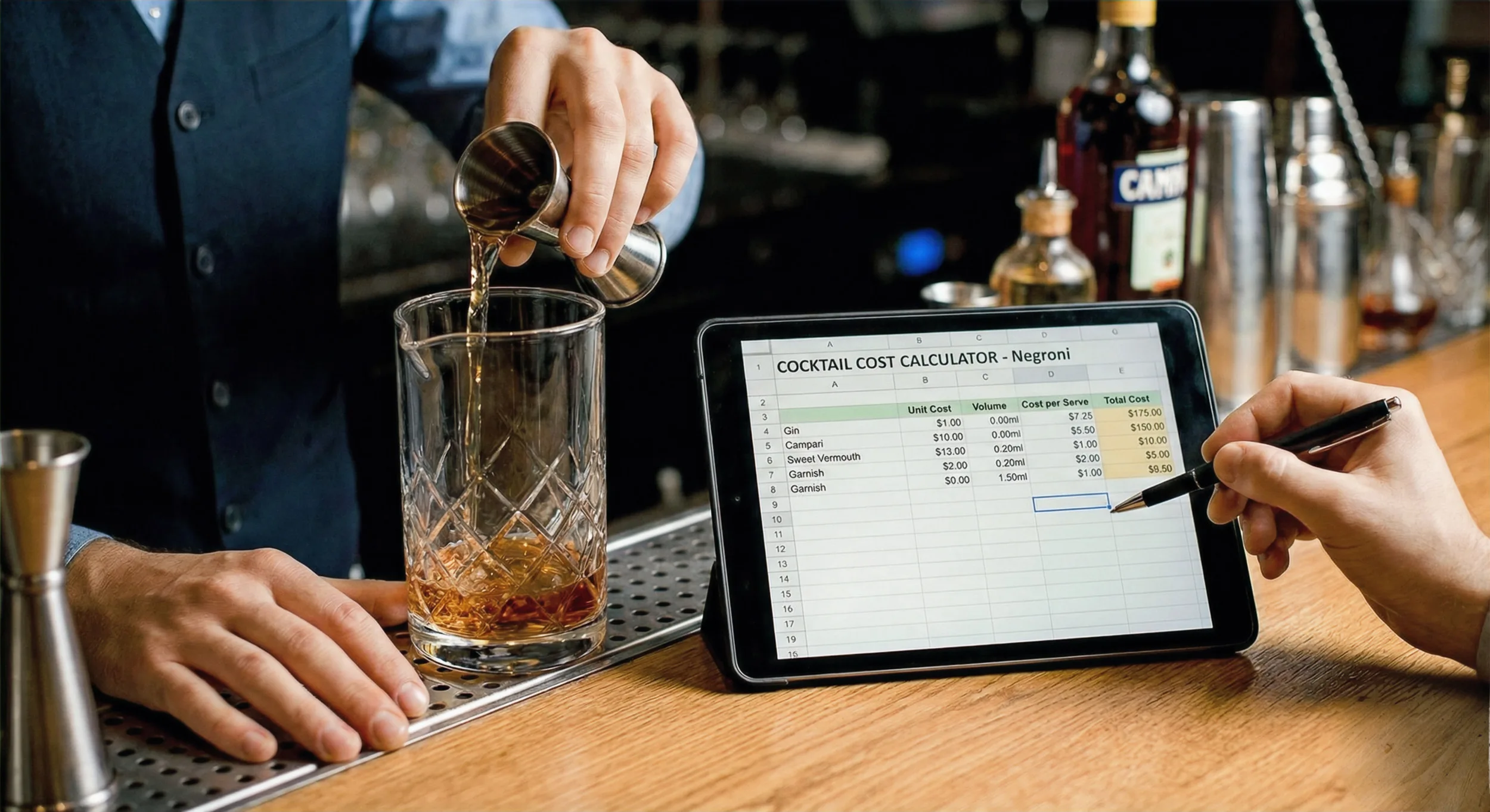 Bartender calculating cocktail costs on a tablet at a bar