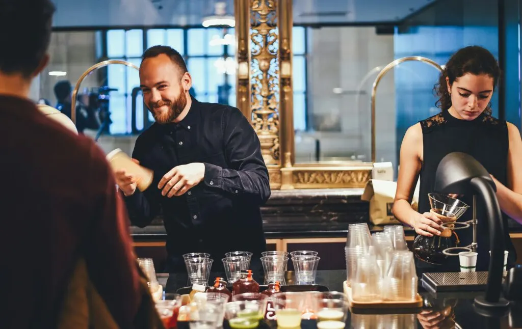 Bartenders preparing drinks at a busy cocktail bar