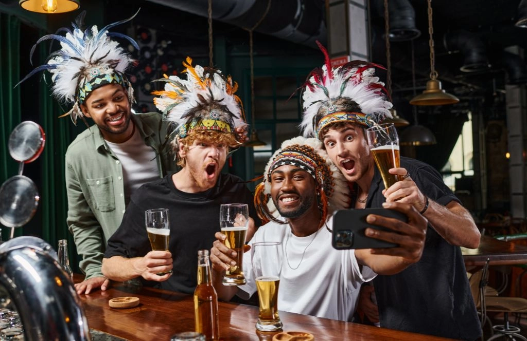 Friends celebrating a bachelor party with beers and a fun group toast.