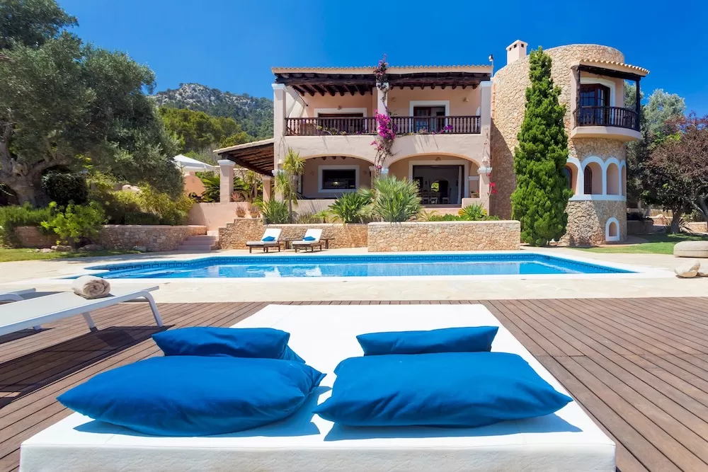 Luxury Ibiza villa with a private pool and sunny outdoor lounge area.