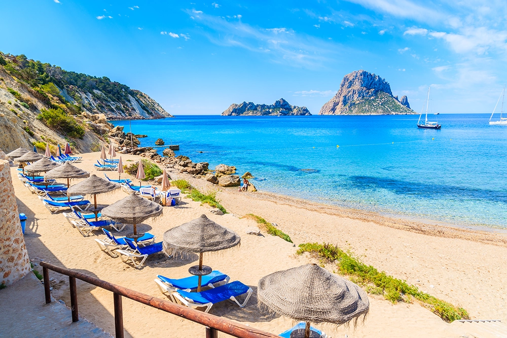 Luxury yacht dining in Ibiza with Mediterranean food, wine, and scenic coastal views.