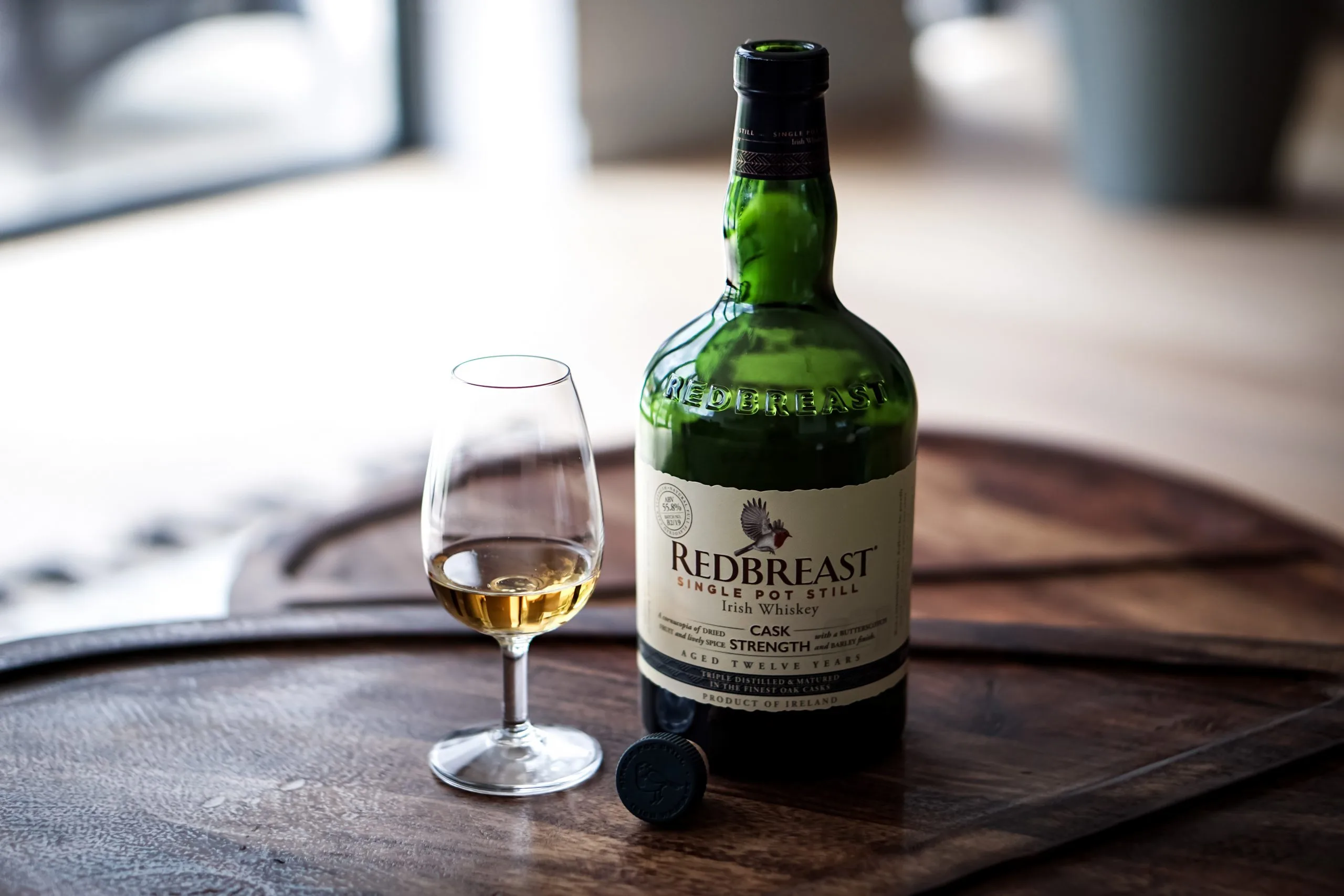 Redbreast Irish whiskey bottle beside a tasting glass.