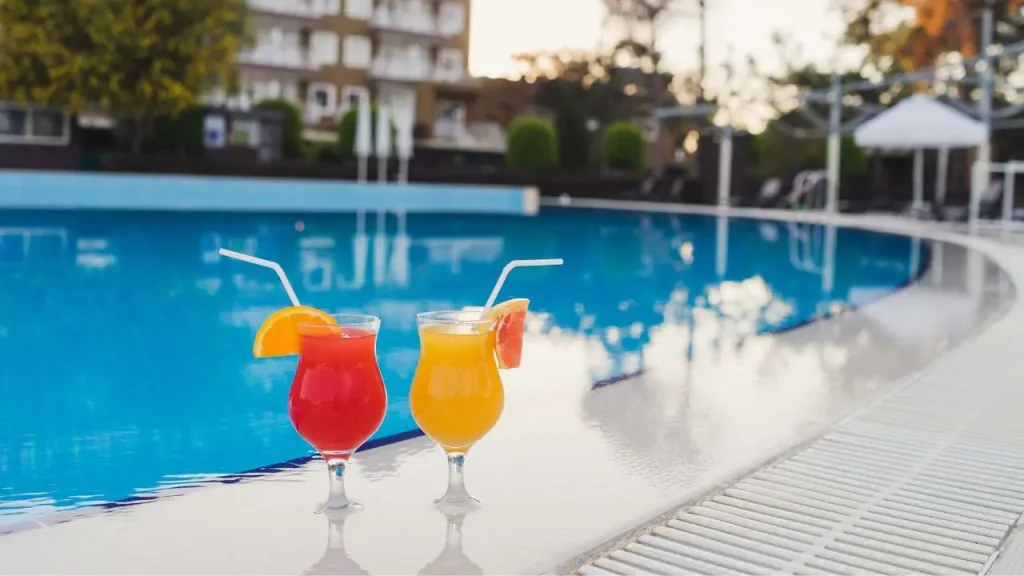 Refreshing cocktails served by a swimming pool during a summer celebration.