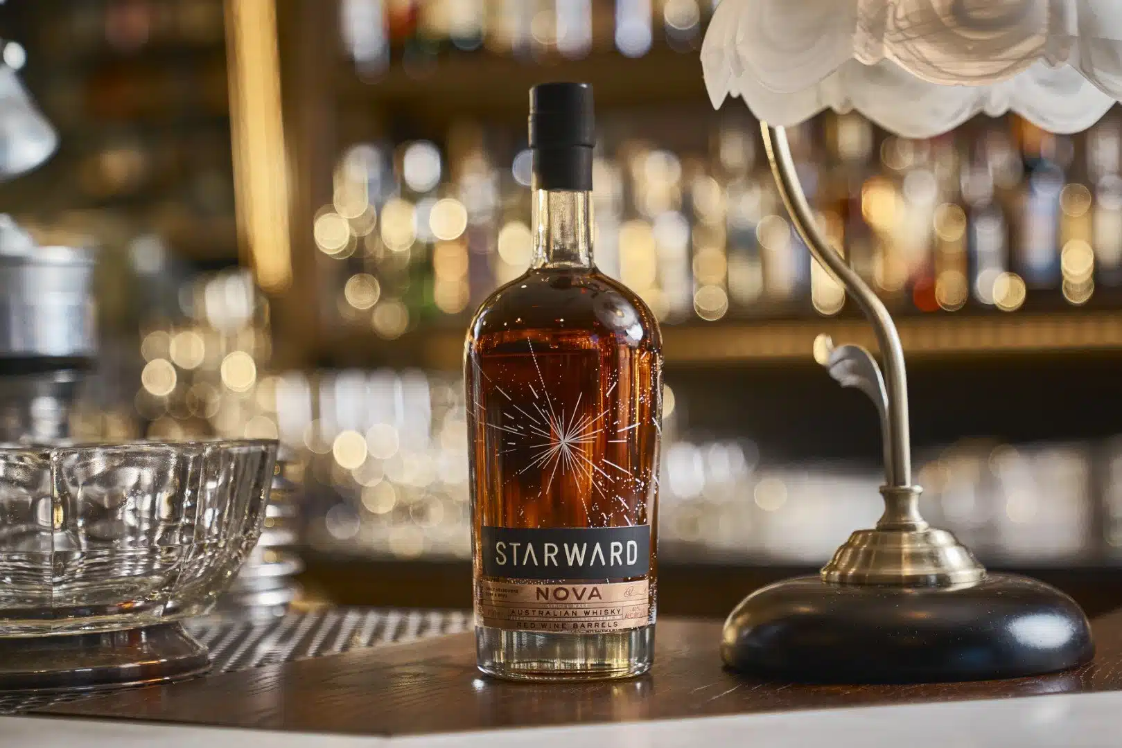 Starward Nova Australian whisky bottle on a bar counter.