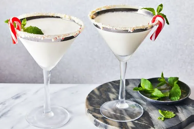 Creamy peppermint martinis garnished with candy canes and fresh mint. (1)