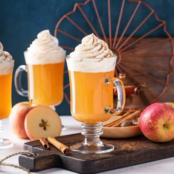 Spiced apple cider topped with whipped cream and cinnamon.